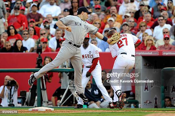 Mark Teixeira of the New York Yankees tags out Vladimir Guerrero of the Los Angeles Angels of Anaheim ending the eighth inning in Game Three of the...