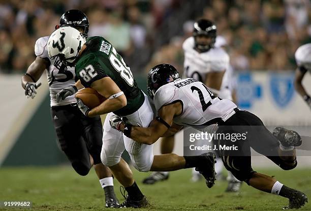 Tight end Ben Busbee of the South Florida Bulls runs after a catch as safety Wesley Richardson of the Cincinnati Bearcats brings him down during the...