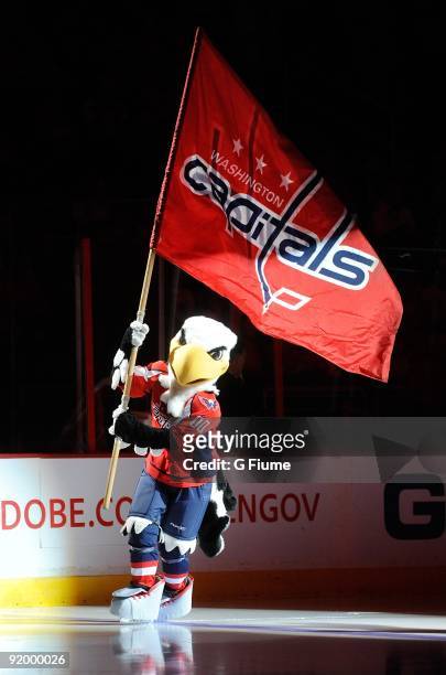 Washington Capitals mascot Slapshot skates down the ice with a flag before the game between the New Jersey Devils and the Washington Capitals at the...