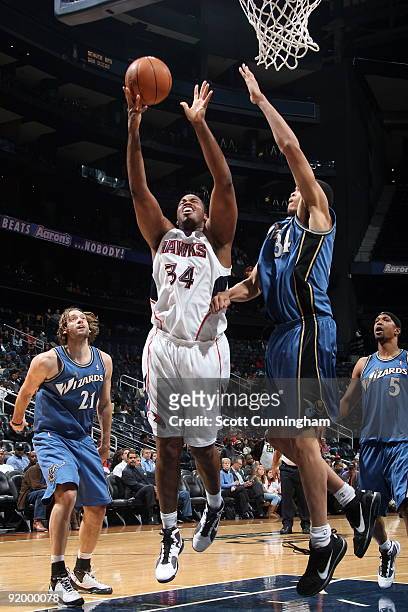 Jason Collins of the Atlanta Hawks puts up a shot against the Washington Wizards during a preseason game on October 19, 2009 at Philips Arena in...