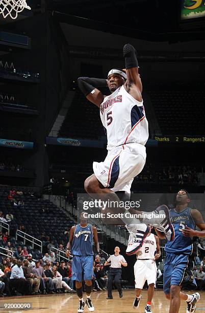 Josh Smith of the Atlanta Hawks goes up for a dunk against the Washington Wizards during a preseason game on October 19, 2009 at Philips Arena in...