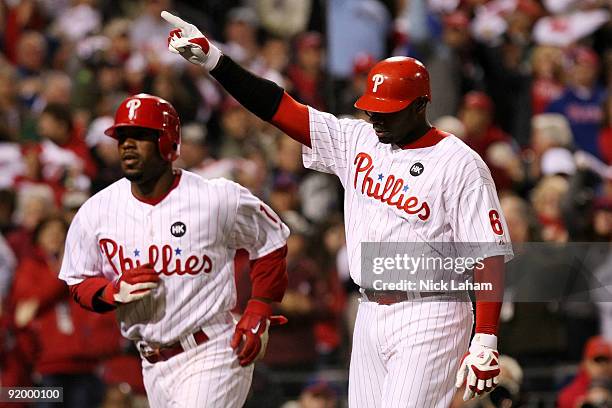 Ryan Howard and Jimmy Rollins of the Philadelphia Phillies celebrate after they both scored on Howard's 2-run home run in the bottom of the first...