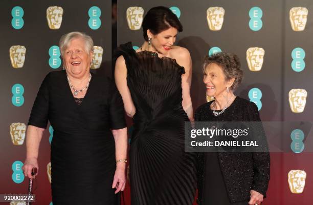 British actress Gemma Arterton poses with Eileen Pullen and Sheila Douglass , former Ford Dagenham sewing machinists, on the red carpet upon arrival...