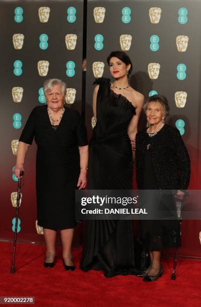 British actress Gemma Arterton poses with Eileen Pullen and Sheila Douglass , former Ford Dagenham sewing machinists, on the red carpet upon arrival...