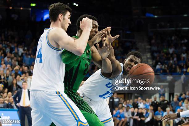 Bruins guard Kris Wilkes and UCLA Bruins forward Gyorgy Goloman defend against Oregon Ducks forward MiKyle McIntosh as he looses control of the ball...