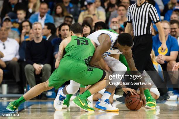 Bruins guard Kris Wilkes fights for a loose ball against Oregon Ducks forward Paul White during the game between the Oregon Ducks and the UCLA Bruins...