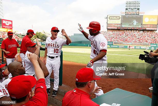 Howie Kendrick of the Los Angeles Angels of Anaheim celebrates with teammates after hitting a home run off Andy Pettitte of the New York Yankees...