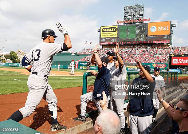 Derek Jeter of the New York Yankees celebrates with teammates after hitting a home run during the first inning off Jered Weaver of the Los Angeles...