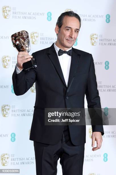 Composer Alexandre Desplat, winner of the Original Music award for the movie "The Shape of Water", poses in the press room during the EE British...