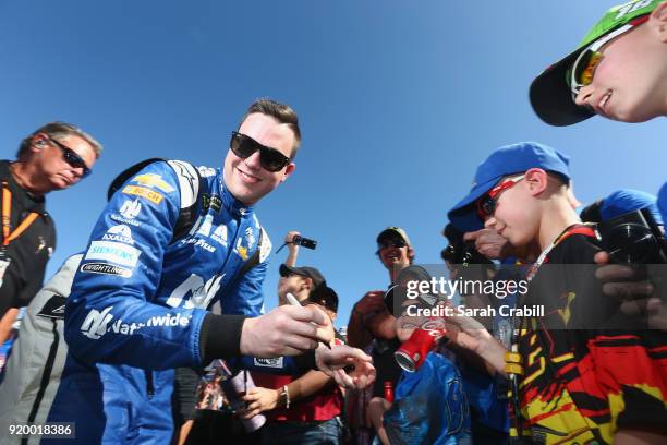 Alex Bowman, driver of the Nationwide Chevrolet, signs autographs prior to the start of the Monster Energy NASCAR Cup Series 60th Annual Daytona 500...