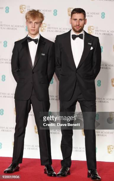 Tom Taylor and Edward Holcroft pose in the press room during the EE British Academy Film Awards held at Royal Albert Hall on February 18, 2018 in...
