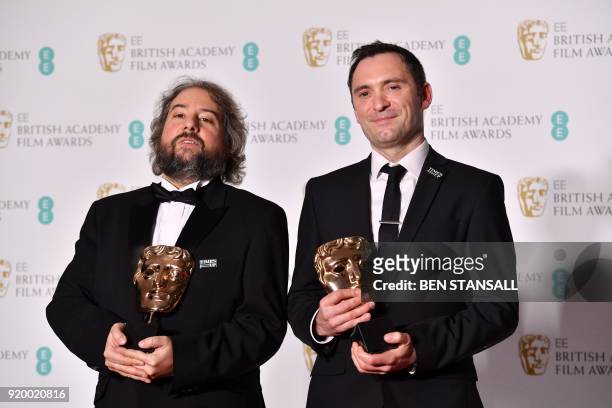 Film editor Jonathan Amos and Australian editor Paul Machliss pose with the award for Editing for work on the film 'Baby Driver' at the BAFTA British...
