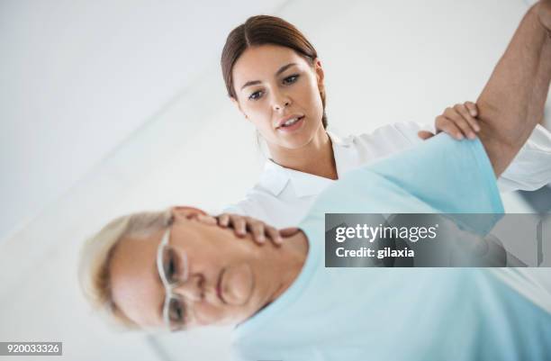 neck pain medical exam. - calcification stock pictures, royalty-free photos & images