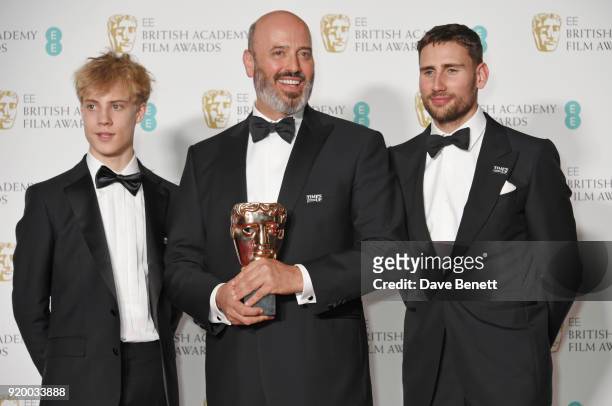 Mark Bridges , winner of the Best Costume Design award for "Phantom Thread", poses with presenters Tom Taylor and Edward Holcroft in the press room...