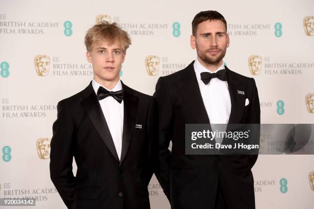 Tom Taylor and Edward Holcroft pose in the press room during the EE British Academy Film Awards held at Royal Albert Hall on February 18, 2018 in...