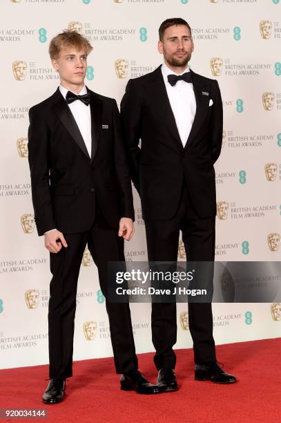 Tom Taylor and Edward Holcroft pose in the press room during the EE British Academy Film Awards held at Royal Albert Hall on February 18, 2018 in...