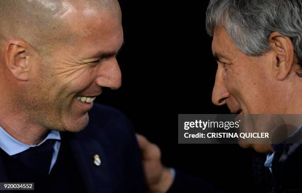 Real Betis' Spanish coach Quique Setien speaks with Real Madrid's French coach Zinedine Zidane before the Spanish league football match Real Betis vs...