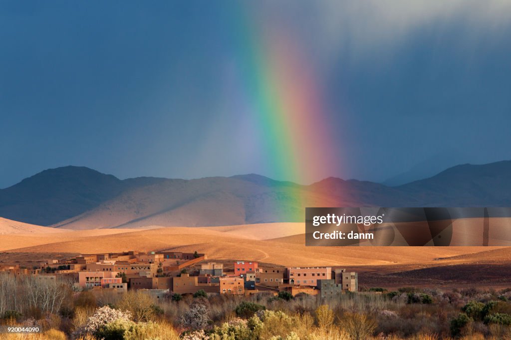 Rainbow over Morocco village in desert