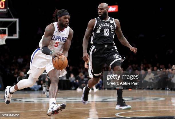 Montrezl Harrell of the LA Clippers works down the court against Quincy Acy of the Brooklyn Nets in the fourth quarter during their game at Barclays...