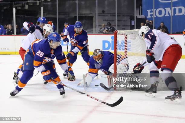 Jaroslav Halak of the New York Islanders defends the goal against Josh Anderson of the Columbus Blue Jackets in the first period during their game at...