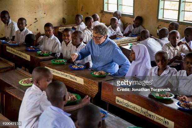 Bill Gates visiting the village of Kicheba in the Tanga region. August 9, 2017 In Kicheba, Tanzanaia. Gates went door-to-door with health workers in...