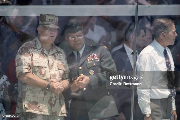 General Norman Schwarzkopf and Joint Chiefs of Staff Chairman General Colin Powell watch the Desert Storm victory parade from the reviewing stand.