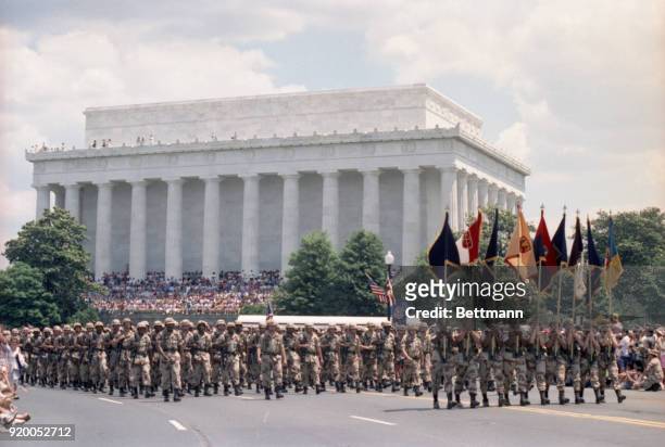 Troops that participated in Operation Desert Storm march past the Lincoln Memorial in the nations capital during a victory parade.