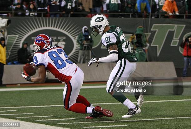 Lee Evans of The Buffalo Bills makes a catch against Dwight Lowery of The New York Jets during their game on October 18, 2009 at Giants Stadium in...