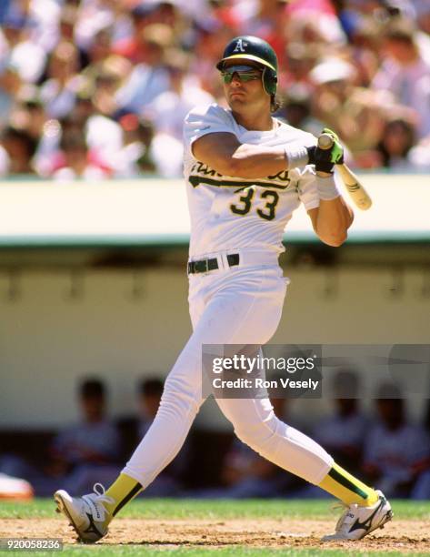 Jose Canseco of the Oakland Athletics bats during a MLB game at The Oakland-Alameda County Coliseum in Oakland, California during the 1992 season.