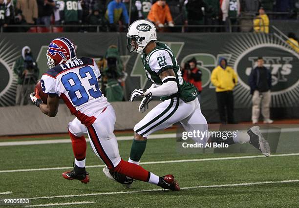 Lee Evans of The Buffalo Bills makes a catch against Dwight Lowery of The New York Jets during their game on October 18, 2009 at Giants Stadium in...