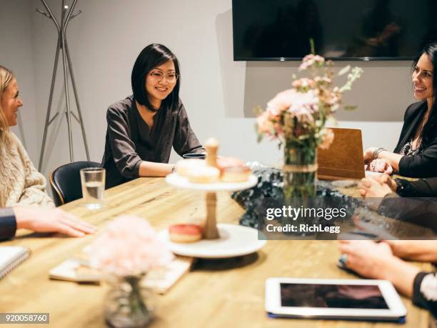 people working in a cafe coffee shop meeting space - event planner stock pictures, royalty-free photos & images