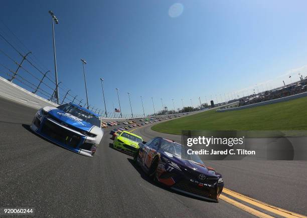 Alex Bowman, driver of the Nationwide Chevrolet, and Denny Hamlin, driver of the FedEx Express Toyota, lead the field prior to the start of the...