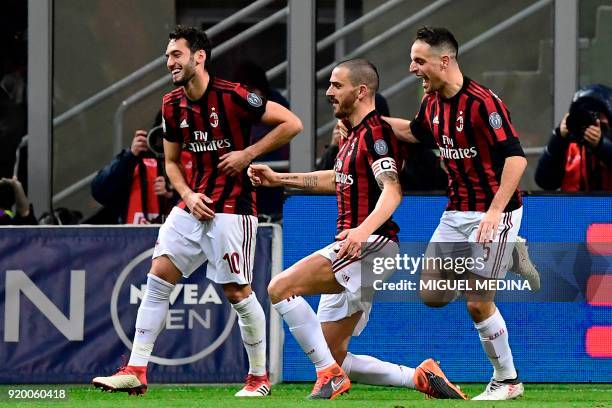 Milan's Captain Italian defender Leonardo Bonucci celebrates with teammates German midfielder Hakan Calhanoglu and Italian midfielder Giacomo...