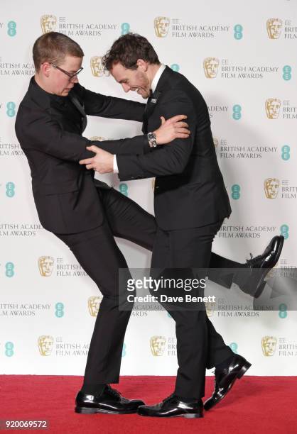 Will Poulter and Sam Claflin pose in the press room during the EE British Academy Film Awards held at Royal Albert Hall on February 18, 2018 in...