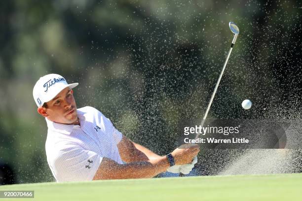 Scott Stallings plays his shot from the bunker on the 10th hole during the final round of the Genesis Open at Riviera Country Club on February 18,...
