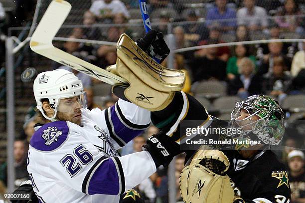 Goaltender Marty Turco of the Dallas Stars hits the puck down against Michal Handzus of the Los Angeles Kings at American Airlines Center on October...