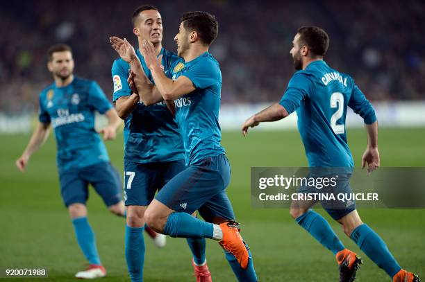 Real Madrid's Spanish midfielder Marco Asensio celebrates a goal with teammates during the Spanish Liga football match Real Betis vs Real Madrid at...