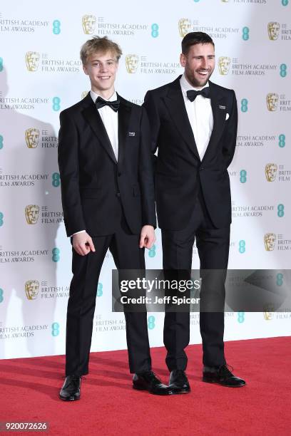 Tom Taylor and Edward Holcroft pose in the press room during the EE British Academy Film Awards held at Royal Albert Hall on February 18, 2018 in...