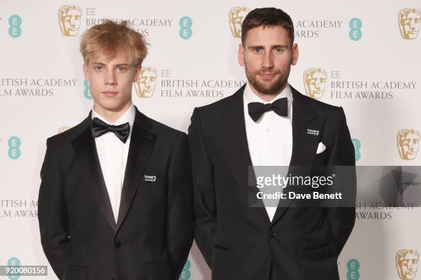 Tom Taylor and Edward Holcroft pose in the press room during the EE British Academy Film Awards held at Royal Albert Hall on February 18, 2018 in...