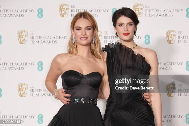 Lily James and Gemma Arterton pose in the press room during the EE British Academy Film Awards held at Royal Albert Hall on February 18, 2018 in...