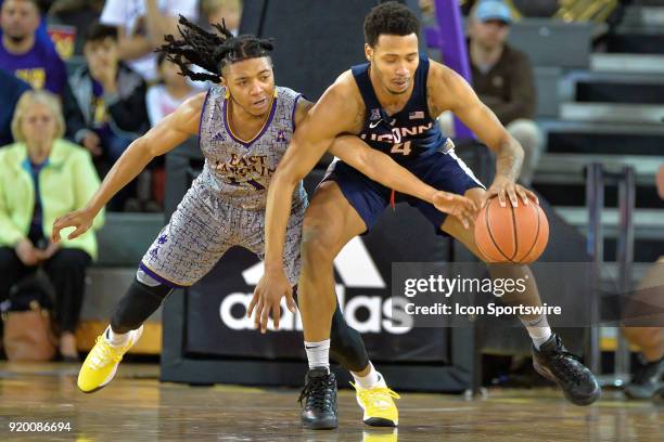 East Carolina Pirates guard Shawn Williams attempts to steal the ball from Connecticut Huskies guard Jalen Adams during a game between the ECU...