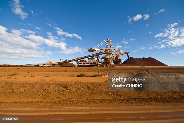 reclaimer stacker on iron ore mine site - australian mining stock pictures, royalty-free photos & images