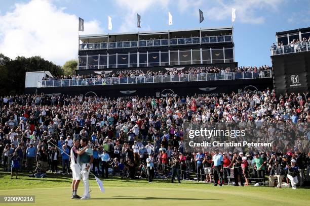 Bubba Watson and caddie Ted Scott celebrate after winning the Genesis Open at Riviera Country Club on February 18, 2018 in Pacific Palisades,...