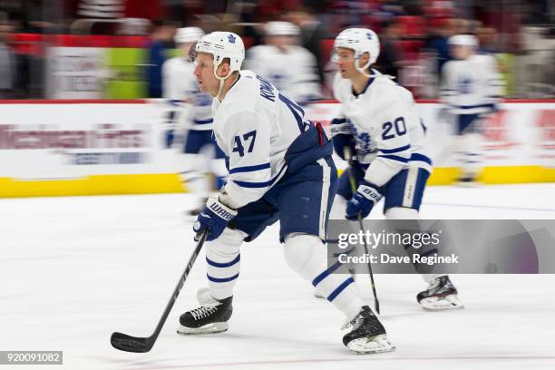 Leo Komarov and Dominic Moore of the Toronto Maple Leafs skate during warm-ups prior to an NHL game against the Detroit Red Wings at Little Caesars...