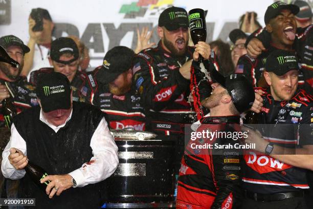 Austin Dillon, driver of the DOW Chevrolet, celebrates with champagne in Victory Lane after winning the Monster Energy NASCAR Cup Series 60th Annual...