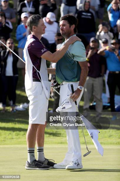 Bubba Watson and caddie Ted Scott celebrate after winning the Genesis Open at Riviera Country Club on February 18, 2018 in Pacific Palisades,...
