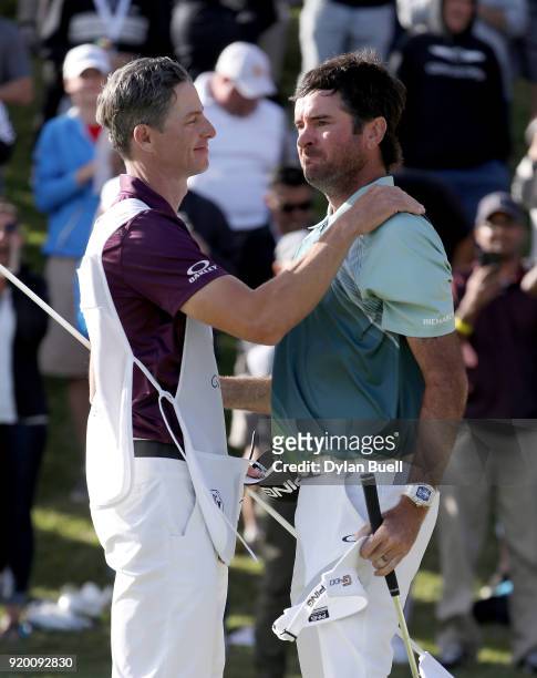 Bubba Watson and caddie Ted Scott celebrate after winning the Genesis Open at Riviera Country Club on February 18, 2018 in Pacific Palisades,...