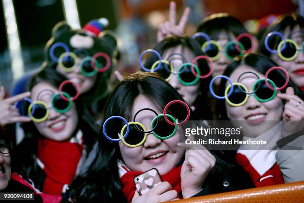 Fans wearing Olympic ring glasses pose during the Medal Ceremony on nine one of the PyeongChang 2018 Winter Olympic Games at Medal Plaza on February...