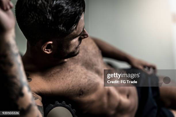 athlete doing exercises - handsome hunks stock pictures, royalty-free photos & images