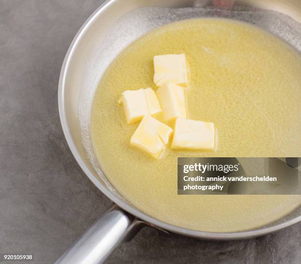 chopped butter in silver skillet. - sciogliere foto e immagini stock
